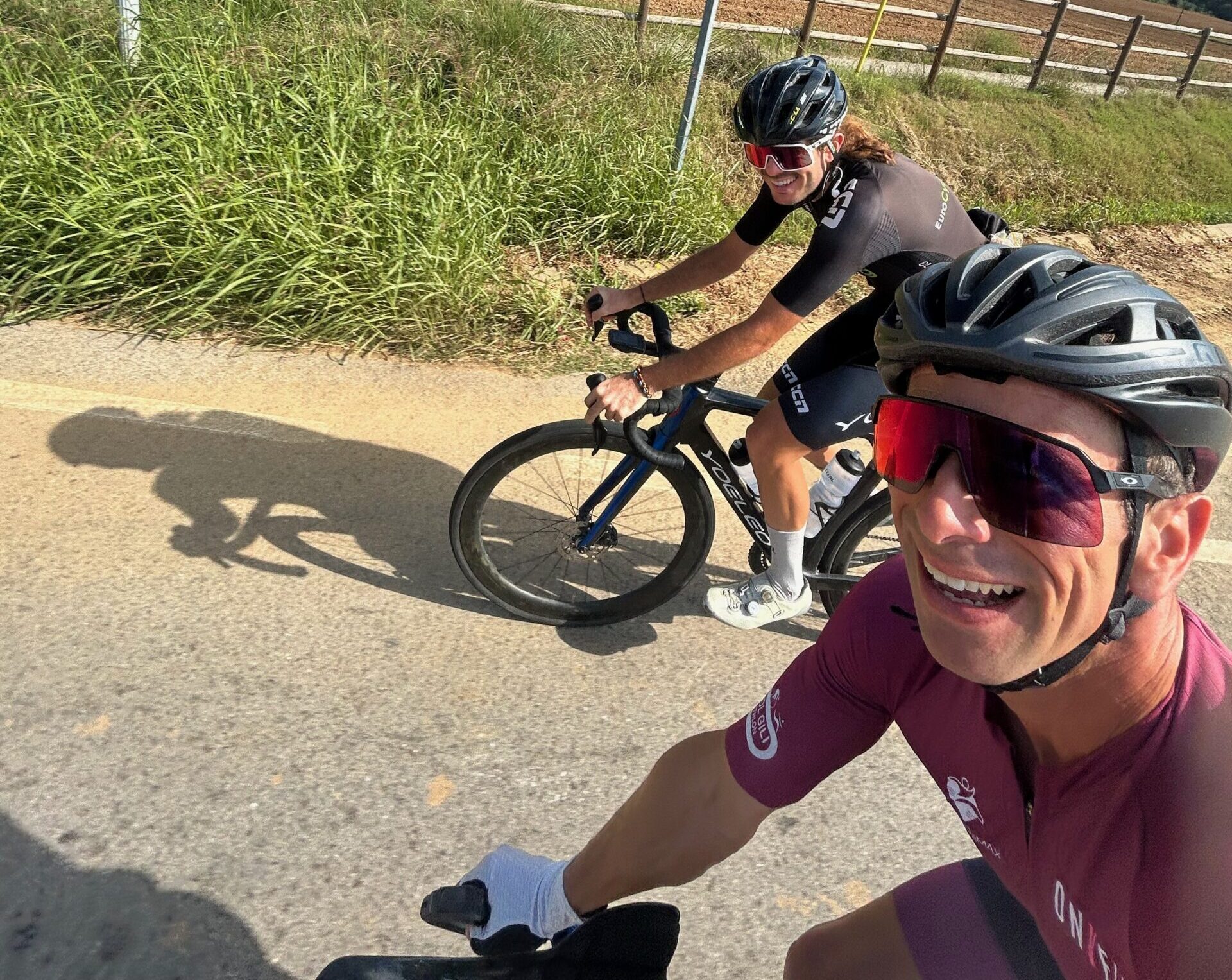 Cyclists smiling for a selfie during a road ride near Girona