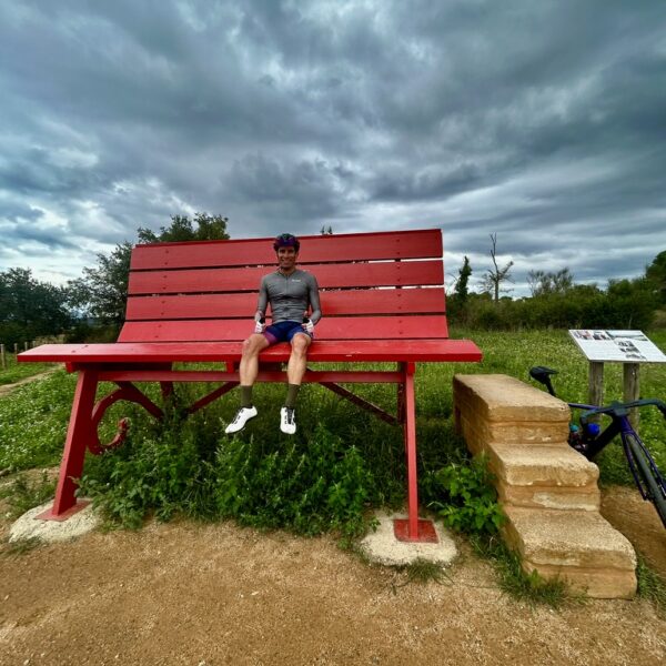 Person sitting on the giant red bench in the countryside near Girona