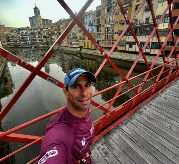 Oriol Gili standing on the iconic red Eiffel bridge in Girona