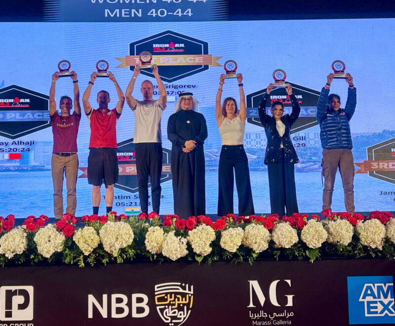 Age-group athletes on the podium at an IRONMAN 70.3 awards ceremony