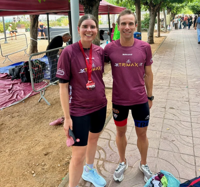 Oriol Gili and a female athlete smiling together after a triathlon training session in Girona